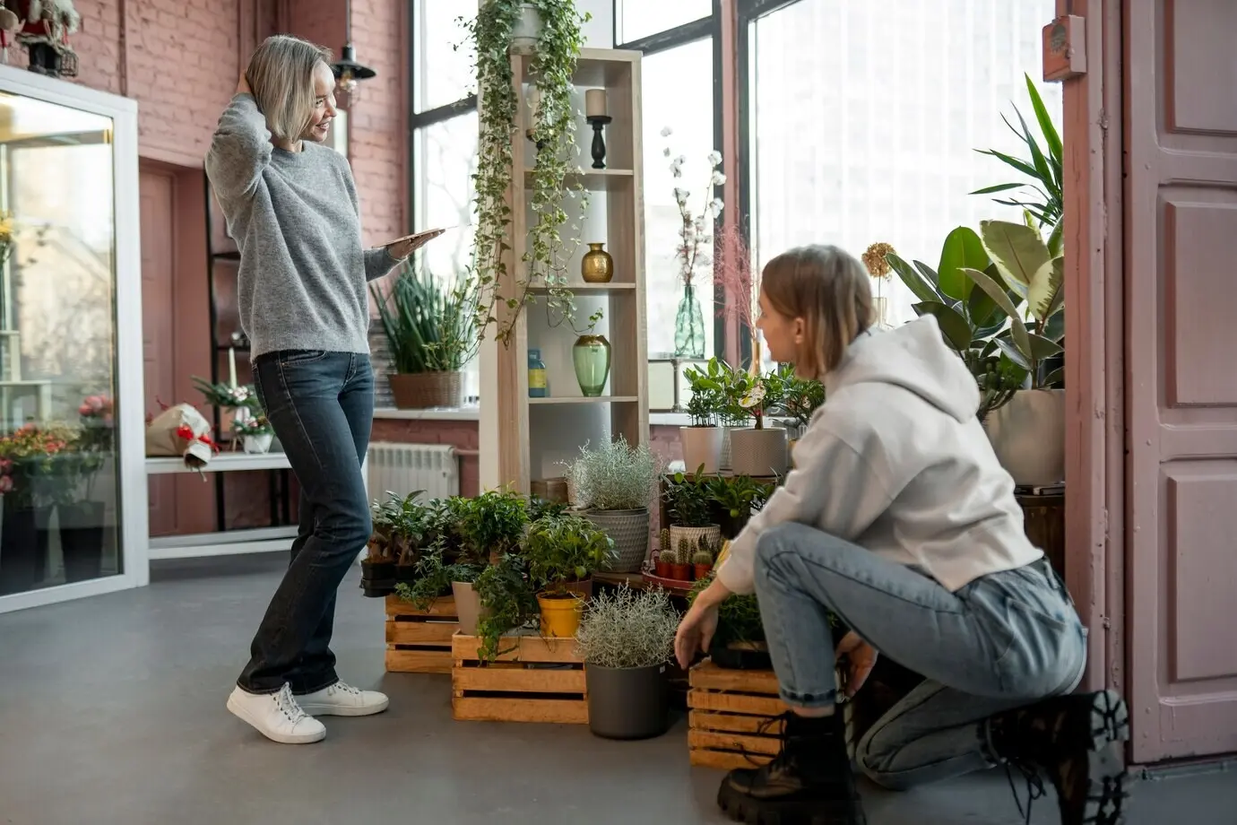 Full shot of women working at a flower shop.